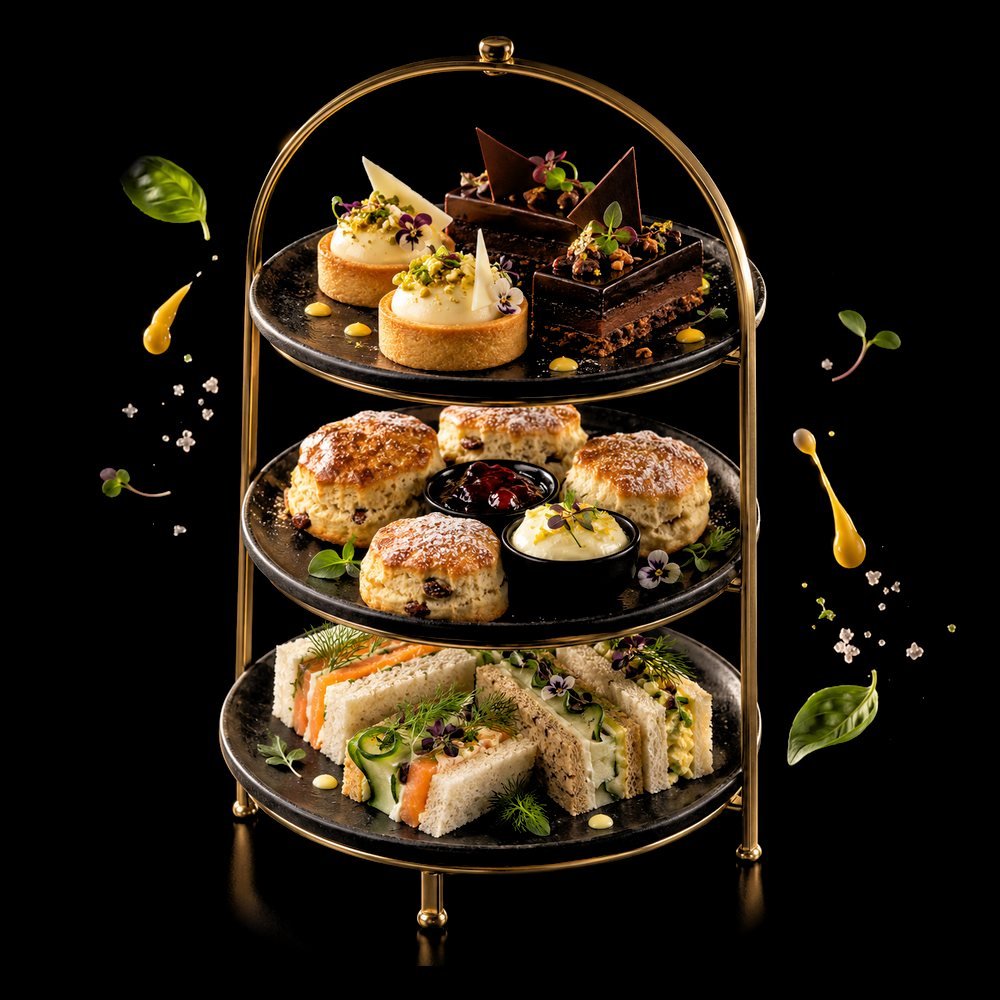 Three-tier High Tea stand with scones, tarts, chocolate slices and finger sandwiches